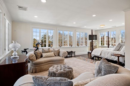 Osterville Cape Cod vacation rental - Luxurious primary suite with a seating area and king bed