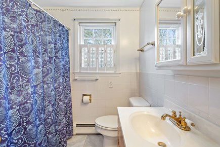Brewster Cape Cod vacation rental - First floor bathroom with tub/shower and closet with bath towels.