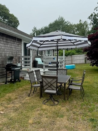 Chatham Cape Cod vacation rental - Backyard with table and chairs, new grill, and outdoor couches