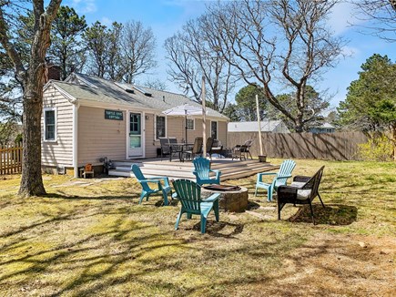 South Yarmouth Cape Cod vacation rental - Backyard with deck and firepit