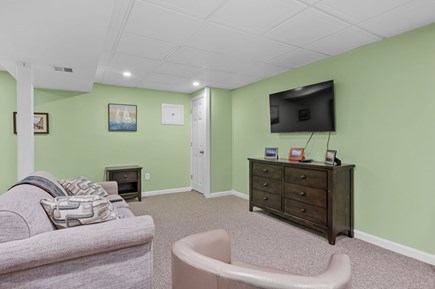 Harwich Port Cape Cod vacation rental - Lower level sitting area with TV