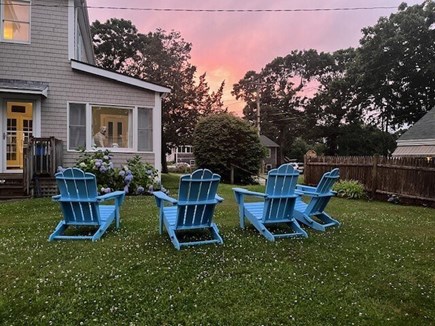 North Falmouth Cape Cod vacation rental - Back yard Adirondack chairs & firepit to watch sunset
