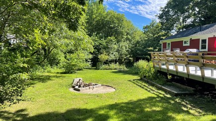 West Yarmouth Cape Cod vacation rental - Large backyard with a firepit just off the deck.