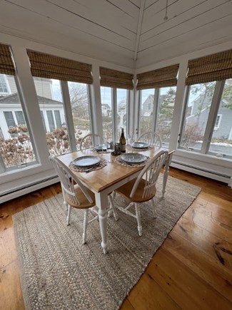 Mashpee, Maushop Village Cape Cod vacation rental - Airy sunroom with kitchen table and ceiling fans and water view
