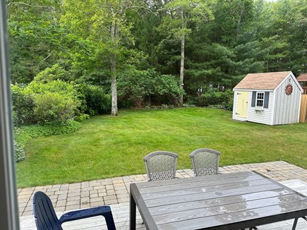 Osterville Cape Cod vacation rental - The backyard has a patio, fire pit, grill, and outdoor shower.