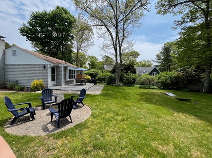 Osterville Cape Cod vacation rental - Large backyard with outdoor shower, grill, and fire pit.