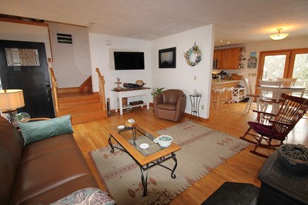 Dennis Cape Cod vacation rental - Family room with adjoining dining and kitchen and stairs