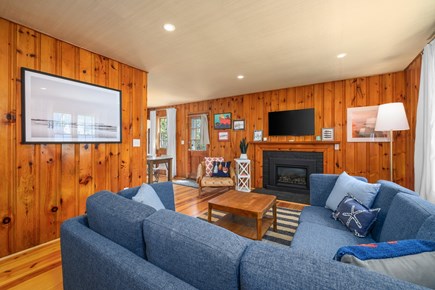 Dennis Port Cape Cod vacation rental - The living room featuring a fireplace, wall-mounted TV and soothing decor