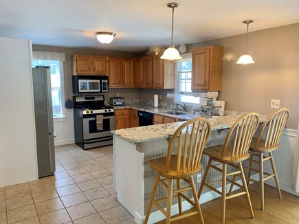 Falmouth, New Silver Beach Cape Cod vacation rental - Spacious, updated kitchen w/ seating for 10 and sliders to patio.