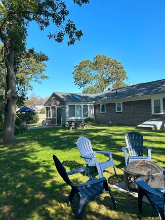 Yarmouth Cape Cod vacation rental - Fenced yard, fire pit, patio table, picnic table, grill, shower.