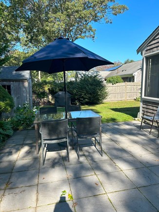 Yarmouth Cape Cod vacation rental - Fenced yard, fire pit, patio table, picnic table, grill, shower.