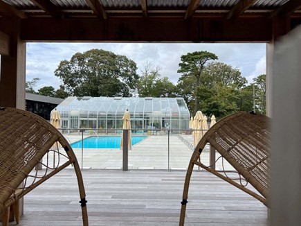 Dennis Port Cape Cod vacation rental - View of neighboring Bluebird outdoor pool from cabana with indoor pool beyond. This area is accessible with purchase of a daily downloadable family pa