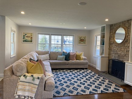 Mashpee Manor Pool House Cape Cod vacation rental - Large open living room, dining, kitchen area with fireplace, TV