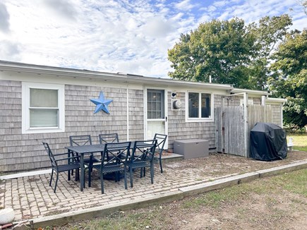 Dennis Port Cape Cod vacation rental - Private backyard: table, gas grill, fire pit, outdoor shower