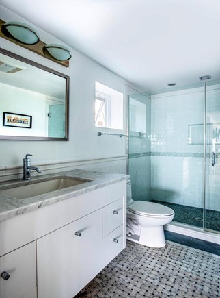 Provincetown Cape Cod vacation rental - Bathroom featuring large walk-in-shower and washer/dryer.