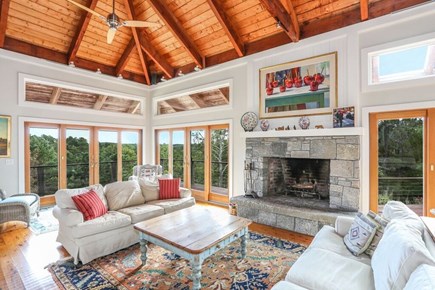 Truro Cape Cod vacation rental - Living area with stone fireplace and soaring ceilings