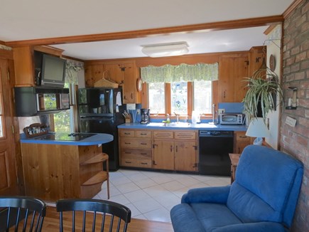 Brewster Cape Cod vacation rental - Note small flat screen TV over kitchen island at left.