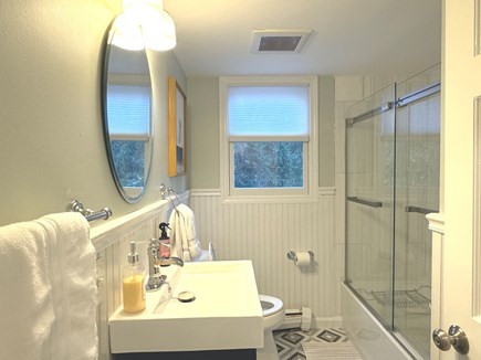 Harwich Cape Cod vacation rental - 1st floor bath: Shower with bathtub, marble tiles