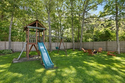 Hyannis Cape Cod vacation rental - Expansive fenced Yard - swing-slide set & firepit