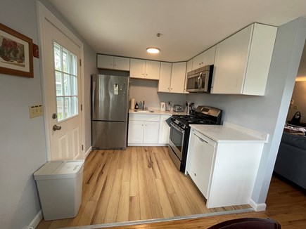 East Falmouth Cape Cod vacation rental - Kitchen leading onto backyard deck