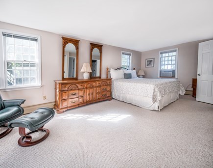 East Orleans Cape Cod vacation rental - Primary bedroom with king bed and en suite access to bathroom