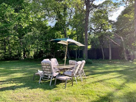 Harwich Captain’s Hill Cape Cod vacation rental - Patio table in large backyard