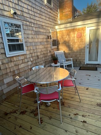 Harwich Captain’s Hill Cape Cod vacation rental - Patio table on back deck located at main house