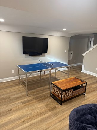 Falmouth Cape Cod vacation rental - Newly finished basement with TV, couches, speakers, and games.