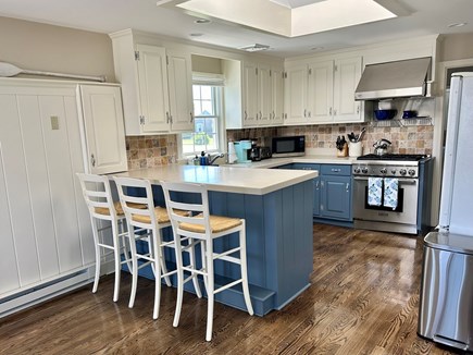 West Dennis Cape Cod vacation rental - Freshly painted kitchen with seating for three at the peninsula.