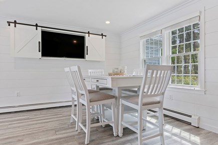 South Dennis Cape Cod vacation rental - Dinette off kitchen with TV and view through solarium
