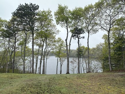 Bourne, Buzzards Bay  Cape Cod vacation rental - View of the lake from the backyard deck, grill, dining set for 6+