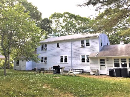 Yarmouth Cape Cod vacation rental - Large, level backyard with outdoor furniture and gas grill