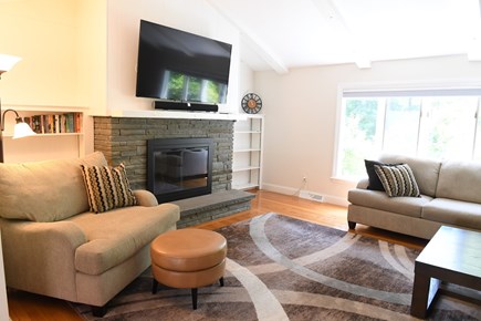 Cotuit Cape Cod vacation rental - Living room with large sectional, fireplace, and 65