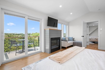 Chatham Cape Cod vacation rental - Inviting Bedroom #3 with Deck, Picturesque Views, and a Gas Fireplace for Full Comfort