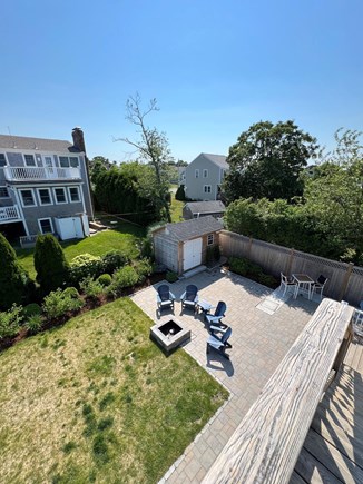 Sandwich, Town Neck Beach Cape Cod vacation rental - Fences in backyard with patio and fire pit.