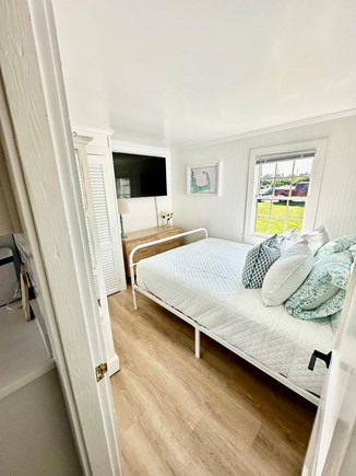 Sandwich, Town Neck Beach Cape Cod vacation rental - Primary bedroom with plush queen bed and flatscreen smart TV.