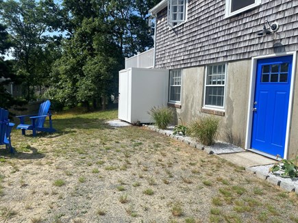 Harwich Cape Cod vacation rental - Back of house with firepit, shower, parking