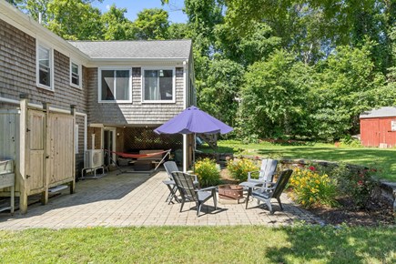 East Dennis Cape Cod vacation rental - Back patio with firepit and outdoor shower