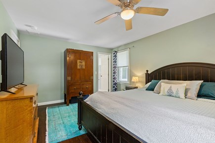 East Dennis Cape Cod vacation rental - Master bedroom with king bed, TV, and ensuite bathroom