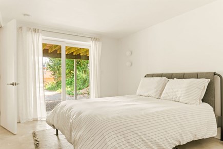 Wellfleet Cape Cod vacation rental - Large bedroom with glass slider and queen bed.