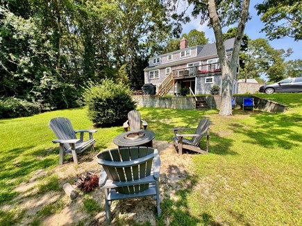 South Yarmouth  Cape Cod vacation rental - Backyard with fire pit and Adirondack chairs