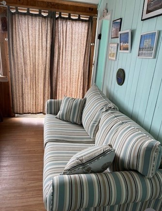 Truro Cape Cod vacation rental - Living room, with sleep sofa, dining table, tv, ocean views.