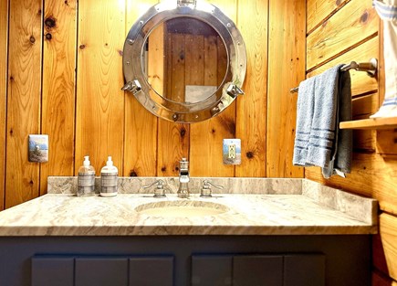 Mashpee Cape Cod vacation rental - First floor bathroom with nautical/Cape Cod mirror