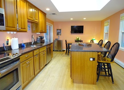 South Yarmouth Cape Cod vacation rental - Kitchen with center breakfast bar, skylight and slider to deck