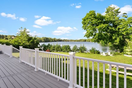 Falmouth Cape Cod vacation rental - Deck w/ couches, dining table, & grill opens to yard/pond/firepit