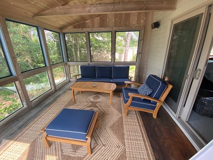 Eastham Cape Cod vacation rental - New teak furniture on screened-in porch off 1st bedroom and deck.