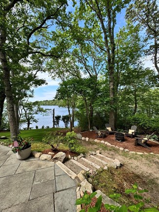 Barnstable Cape Cod vacation rental - Side view of our stone patio leading to our upper fire-pit oasis