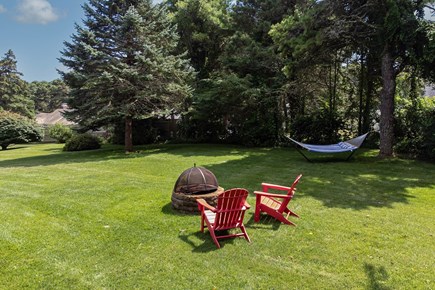 South Chatham Cape Cod vacation rental - Lawn chairs, fire pit, and hammock.