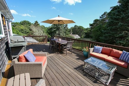 South Chatham Cape Cod vacation rental - Large back deck, with grill, dining table and comfy seating.