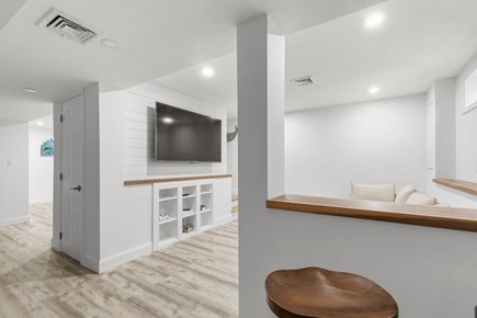 Falmouth Cape Cod vacation rental - TV room with large sectional couch and bar seating.
